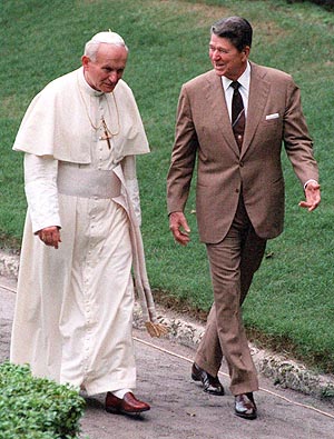 Pope John Paul II, left, walks with President Ronald Reagan in the garden of the Vizcaya, a lavish mansion on Biscayne Bay, Thursday, Sept. 10, 1987, in Miami. The CIA worked closely with Pope John Paul II to hasten the fall of communism in Poland, according to a new book co-written by Watergate reporter Carl Bernstein. As part of the informal alliance, the book claims, President Reagan cut off funding for abortion programs overseas, and the pope kept silent on U.S. efforts to install cruise missiles in Western Europe. (AP Photo/Scott Stewart)